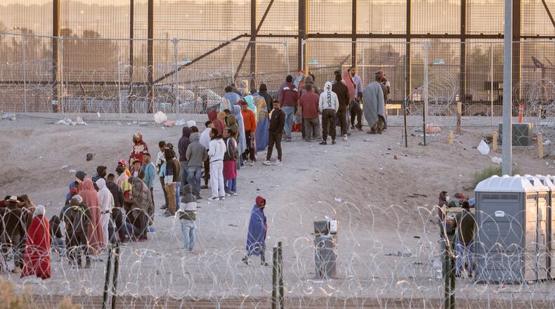 Immigrants wait to be transported and processed by U.S. Border Patrol officers at the U.S.-Mexico border on May 12, 2023, in El Paso, Texas. (John Moore/Getty Images/TNS)