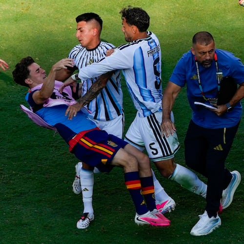 Spain's Gavi, left, falls as he scuffles with Argentina's Leandro Paredes (5) and Thiago Almada during the World Cup final soccer match between Spain and Argentina in East Rutherford, N.J., near New York, Sunday, July 19, 2026. (AP Photo/Yuki Iwamura)