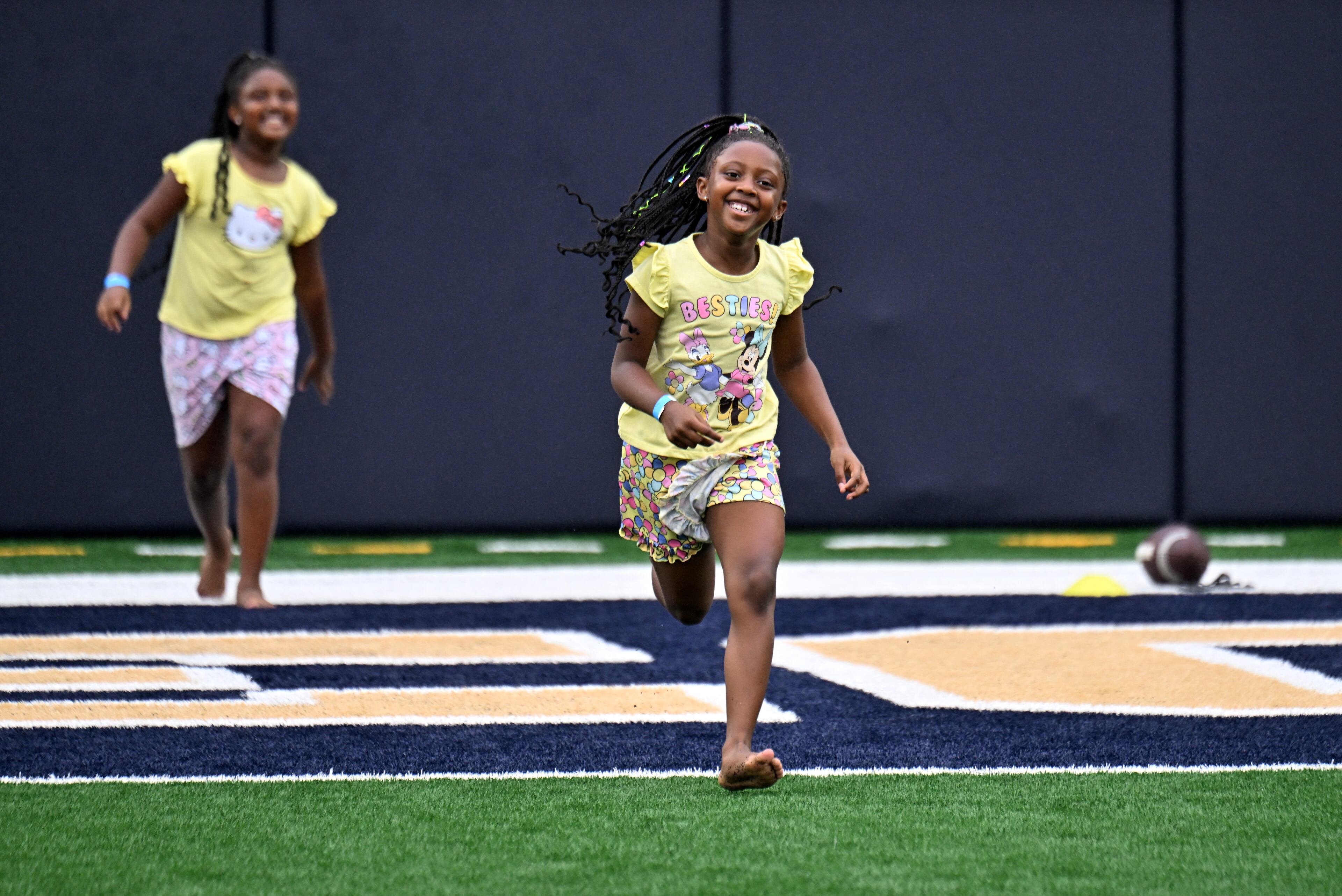Maddison Blassingame, 6, and her sister Malia (background), 7, enjoy a variety of entertaining activities during the annual “First Saturday on The Flats” at Bobby Dodd Stadium, Saturday, August 2, 2025, in Atlanta. The Flats provides Tech fans with the opportunity to engage with their favorite Yellow Jackets ahead of the upcoming 2025 season. The event offers a variety of entertaining activities for the whole family, including a DJ, autograph opportunities, tailgate games and interactive experiences right on the field at Bobby Dodd Stadium. (Hyosub Shin / AJC)