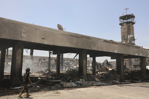 A Yemeni officer inspects the damage following Israeli airstrikes on Sanaa International Airport in Sanaa, Yemen, Wednesday, May 7, 2025. (AP Photo/Osamah Abdulrahman)