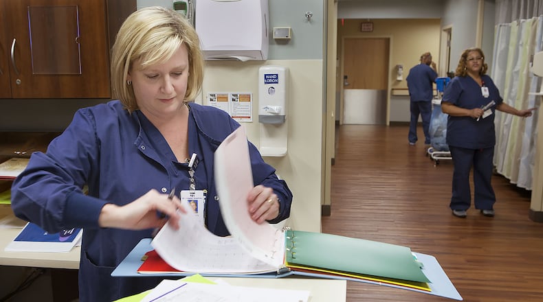 Registered Nurse Bethany Leftwich goes through paperwork at the nurse’s station in the Cardiac Cath Lab at Northside Hospital. Photo by Phil Skinner