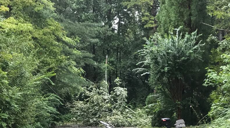 Two downed trees and a broken utility pole lie in the road on Village Court in Snellville after Tropical Storm Irma rolled through.