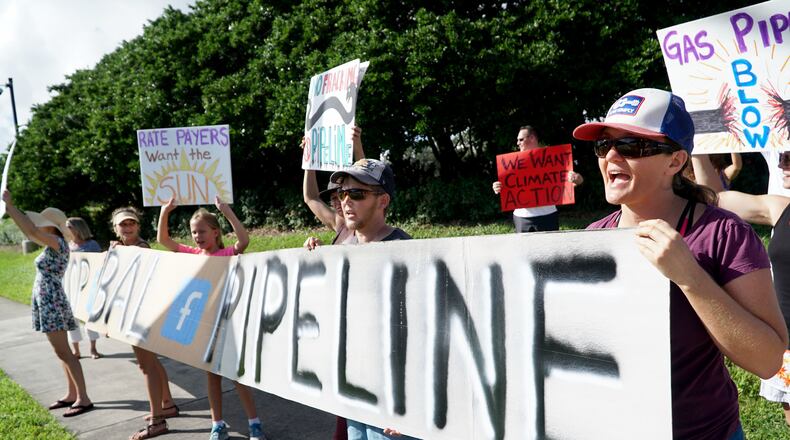 Catherine Doe, right, of West Palm Beach, joins gas pipeline protesters outside of Florida Power and Light headquarters on Universe Boulevard in Juno Beach on October 14, 2016. The Sabal Trail Pipeline is slated to bring natural gas to FPL’s South Florida plants in 2017. Groups oppose the 515-mile pipeline that will start in Alabama and bring fracked gas through several counties in Florida’s springs and wetlands. (Richard Graulich / The Palm Beach Post)