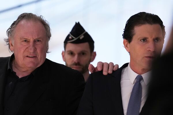 Actor Gerard Depardieu arrives with his lawyer Jeremie Assous, right, to face trial for the alleged sexual assaults of two women on a film set in 2021, Monday, March 24, 2025 in Paris. (AP Photo/Aurelien Morissard)