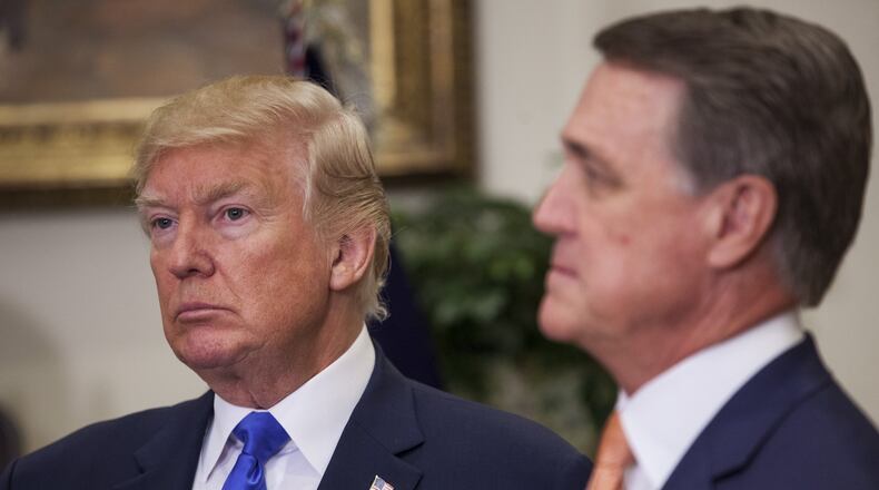 President Donald Trump, left, and U.S. Sen. David Perdue first met five years ago and worked closely since Trump took office in 2017. Perdue, who is up for re-election next year, plays up the connection on the campaign trail. “He calls me early in the morning and late at night. I spend time with him in the White House. Sometimes he’s exhausting, guys, but he works,” Perdue said of Trump at a recent gathering of religious conservatives. His opponents are also trying to tie him to the president. Photo by: Zach Gibson/picture-alliance/dpa/AP Images