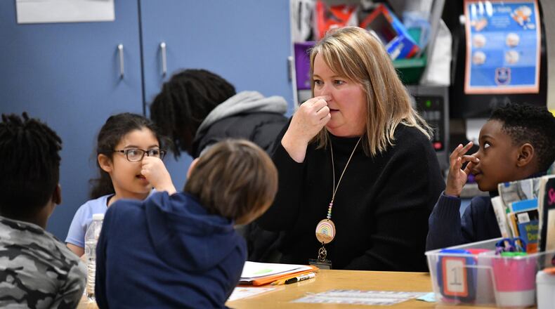 Teaching coach Katie Gaudette leads a small group during a literacy lesson in Jennifer Brems' first grade classroom at A.L. Burruss Elementary School on Feb. 3, 2023, in Marietta. (Hyosub Shin/Hyosub.Shin@ajc.com)
