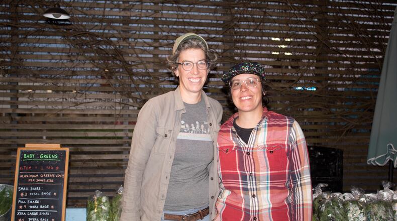 Annie Moore (left) and Cheryl Nunes wrap up their space after a CSA day in one of SPROUT’s community gardens. (Photo by Autumn Jemison)