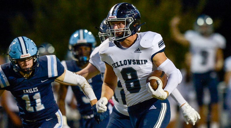 Fellowship Christian running back Josh Cole (8) carries the ball for a touchdown early in the first quarter of his game at North Cobb Christian Friday.