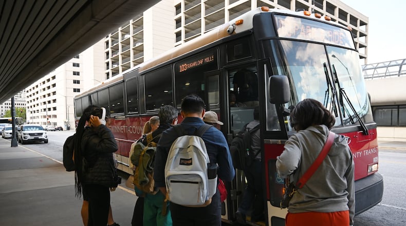 Customers get on Gwinnett County Transit bus at the Civic Center MARTA station, Thursday, September 19, 2024, in Atlanta. (Hyosub Shin / AJC)