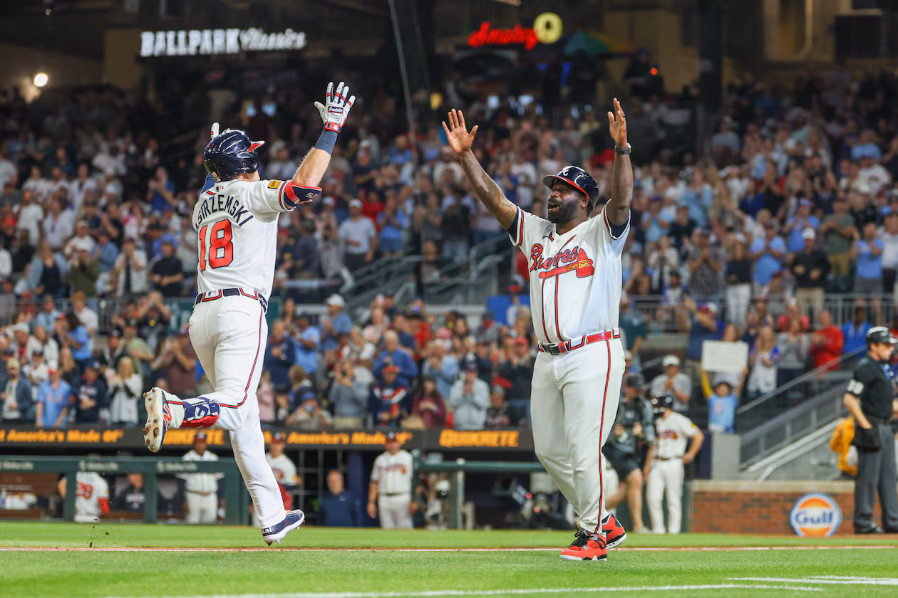 Braves left fielder Mike Yastrzemski (left) celebrates with third base coach Tommy Watkins after hitting a home run in the fifth inning against the Cubs on Tuesday, May 12, 2026, at Truist Park in Atlanta. (Arvin Temkar/AJC)