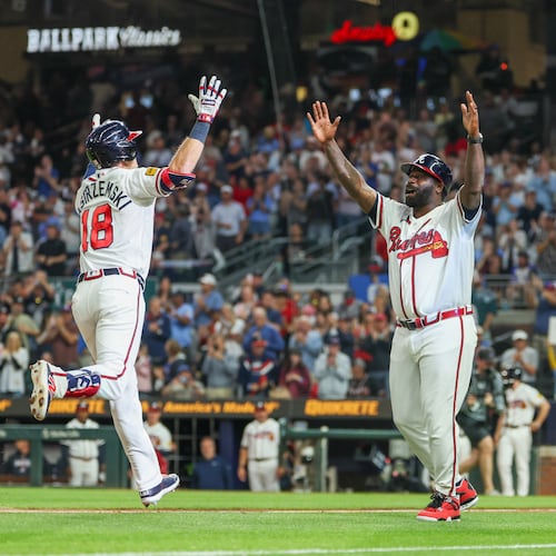 Atlanta Braves left fielder Mike Yastrzemski (18) celebrates with Atlanta Braves third base coach Tommy Watkins (84) after hitting a home run in the fifth inning of the Braves versus Cubs game at Truist Park in Atlanta on May 12, 2026. (Arvin Temkar/AJC)