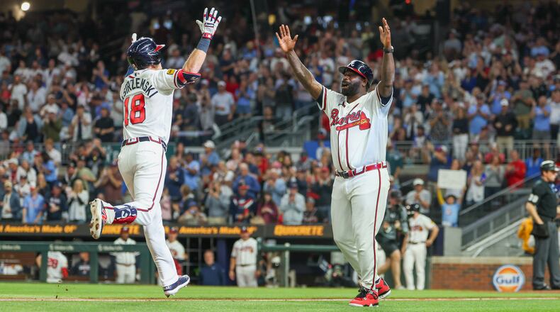 Atlanta Braves left fielder Mike Yastrzemski (18) celebrates with Atlanta Braves third base coach Tommy Watkins (84) after hitting a home run in the fifth inning of the Braves versus Cubs game at Truist Park in Atlanta on May 12, 2026. (Arvin Temkar/AJC)