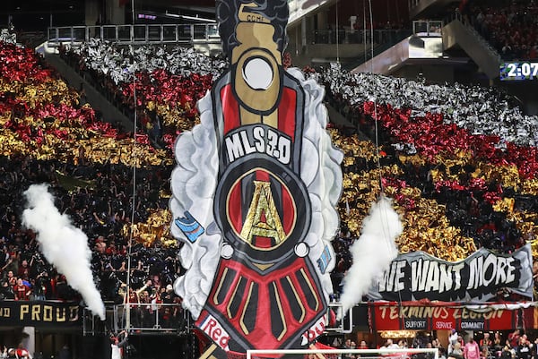 12/8/18 - Atlanta -  Atlanta United fans hoist a tifo to begin the match against the Portland Timbers for the MLS Cup, the championship game of the Major League Soccer League at Mercedes-Benz Stadium in Atlanta.   CURTIS COMPTON / CCOMPTON@AJC.COM