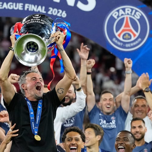 PSG's head coach Luis Enrique lifts the trophy celebrating after winning the Champions League final soccer match between Paris Saint-Germain and Arsenal in Budapest, Hungary, Saturday, May 30, 2026. (AP Photo/Petr Josek)