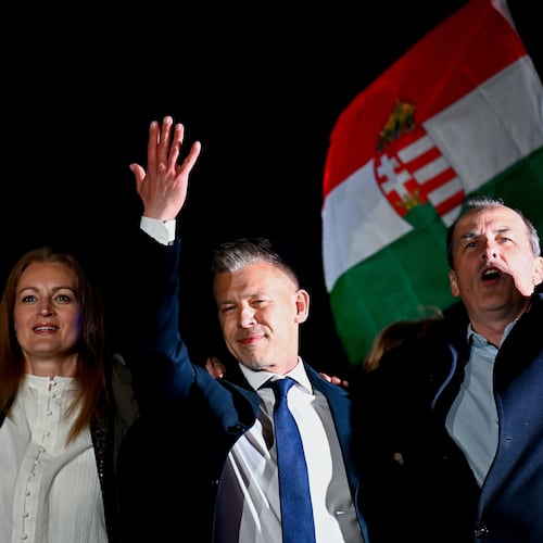 Peter Magyar, leader of the opposition Tisza party, center, celebrates with his party colleagues following the announcement of the partial results of the parliamentary election, in Budapest, Hungary, Sunday, April 12, 2026. (AP Photo/Denes Erdos)
