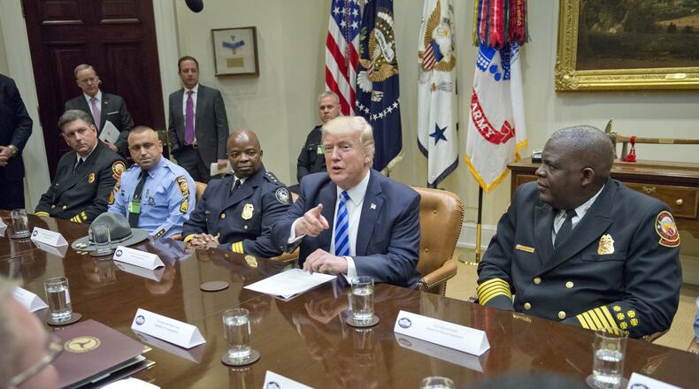 President Donald Trump meets Thursday at the White House with the first responders from the I-85 bridge collapse. (Photo by Ron Sachs - Pool/Getty Images)
