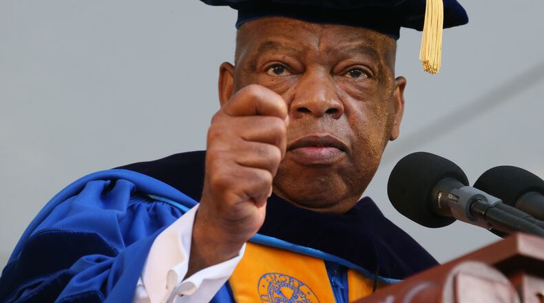 U.S. Rep. John Lewis addresses Emory University graduates in his moving 2014 commencement address, where Lewis encouraged a new generation of political activists to cause "good trouble" to bring about positive change in the country. Lewis died in July 2020. (Staff file photo by Bob Andres / AJC)