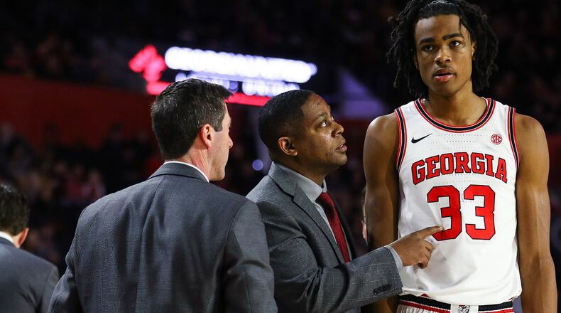 Georgia assistant coach Chad Dollar (center) chats with Georgia forward Nicolas Claxton (33) following the end of a timeout during a men's basketball game betweenGeorgia and Ole Miss at Stegeman Coliseum on Saturday, Feb. 9, 2019. Georgia assistant coach Joe Scott (left) is part of the conversation. (Photo by Kristin M. Bradshaw/UGA)