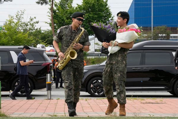 FILE - K-pop band BTS members RM, left, and V react after being discharged from a mandatory military service in Chuncheon, South Korea, Tuesday, June 10, 2025. (AP Photo/Ahn Young-joon, File)