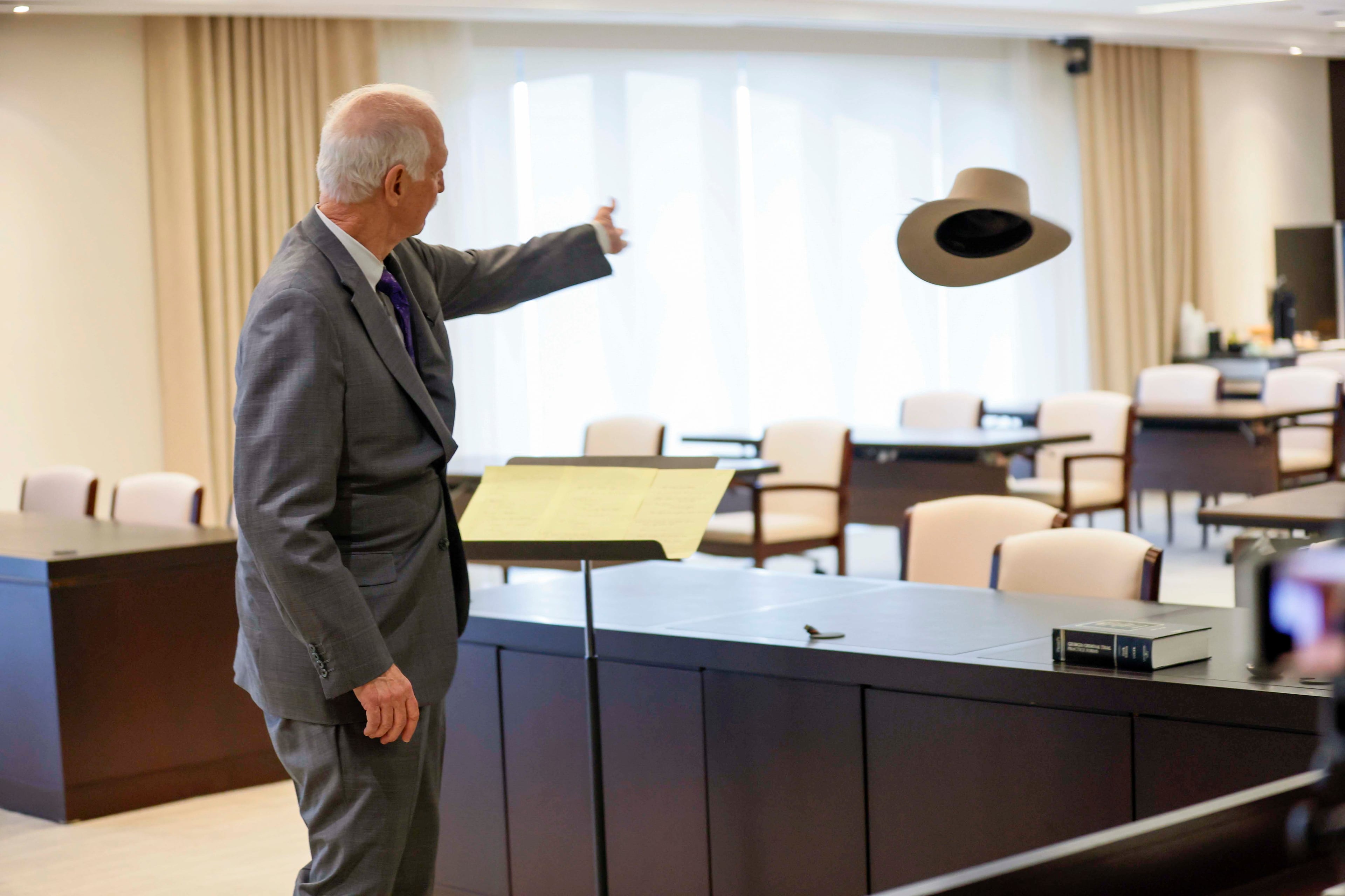 Dalton-based litigator Ralph Hinman tosses a cowboy hat across the courtroom of Alston & Bird's office in Midtown as he presents a closing argument in a mock trial as part of a skills workshop. (Miguel Martinez/AJC)