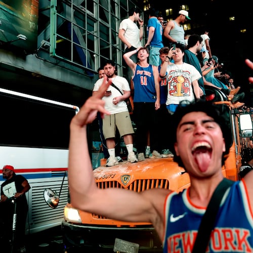 New York Knicks fans celebrate their victory after Game 5 of the NBA Finals basketball series against the San Antonio Spurs, Saturday, June 13, 2026, in New York. (AP Photo/Heather Khalifa)