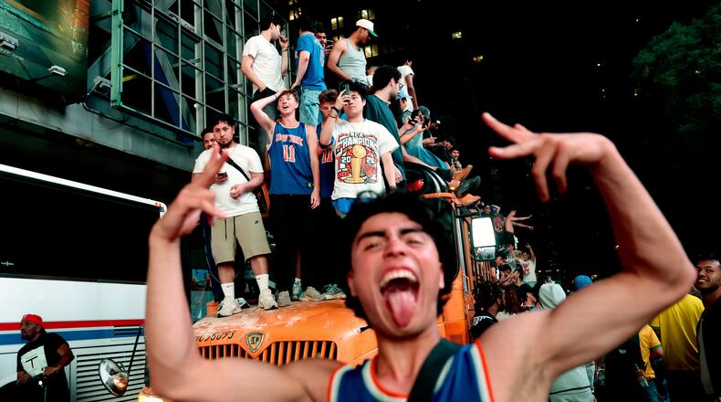 New York Knicks fans celebrate their victory after Game 5 of the NBA Finals basketball series against the San Antonio Spurs, Saturday, June 13, 2026, in New York. (AP Photo/Heather Khalifa)