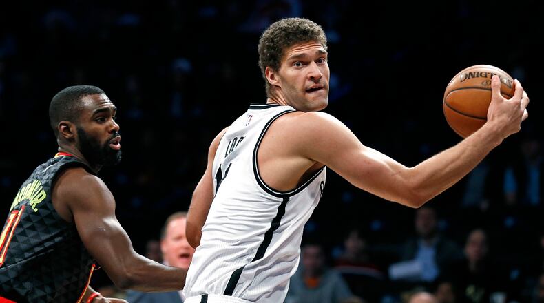 Brooklyn Nets center Brook Lopez drives to the basket past Atlanta Hawks guard Tim Hardaway Jr. during the first half of an NBA basketball game Sunday, April 2, 2017, in New York. The Nets won 91-82. (AP Photo/Adam Hunger)p