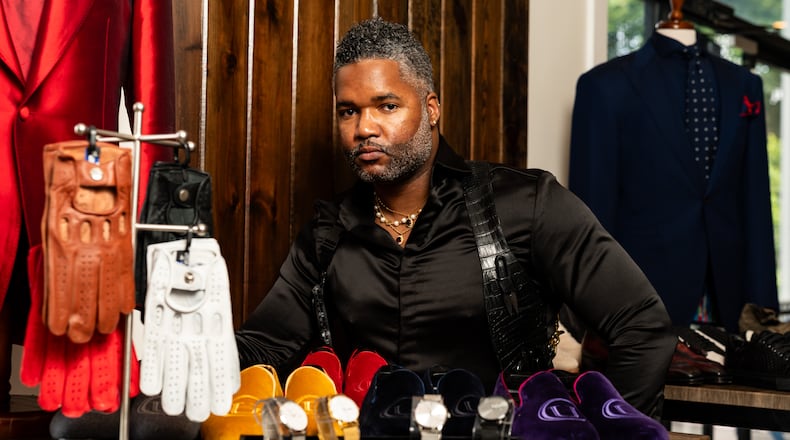 Tailor Carl Ulysses stands with items he designed at The 500 Apartments in Atlanta on Friday, June 28, 2024. (Seeger Gray / AJC)