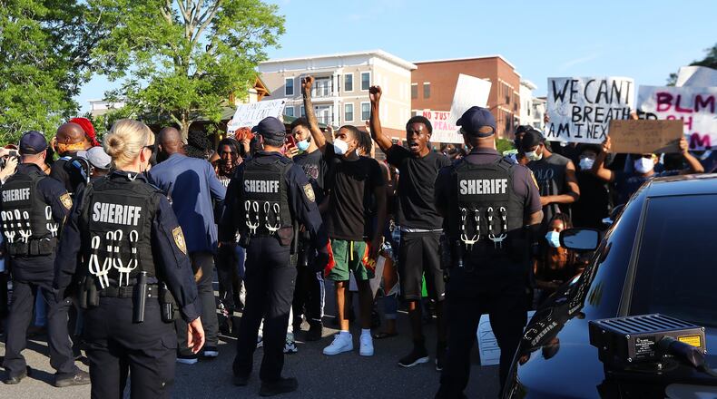 Protesters and police face off on South Clayton Street a few blocks from Lawrenceville City Hall as protests continue for a fourth day around metro Atlanta over the death of George Floyd on Monday, June 1, 2020, in Lawrenceville. Curtis Compton ccompton@ajc.com