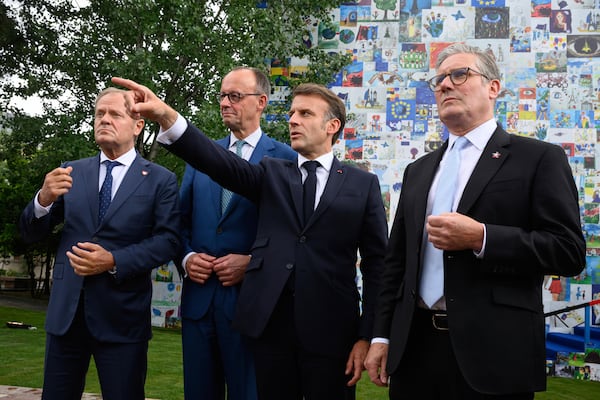 From left, Poland's Prime Minister Donald Tusk, Germany's Chancellor Friedrich Merz, France's President Emmanuel Macron and Britain's Prime Minister Keir Starmer talk to the press after their meeting Friday May 16, 2025 in Tirana, Albania. (Leon Neal/Pool via AP)