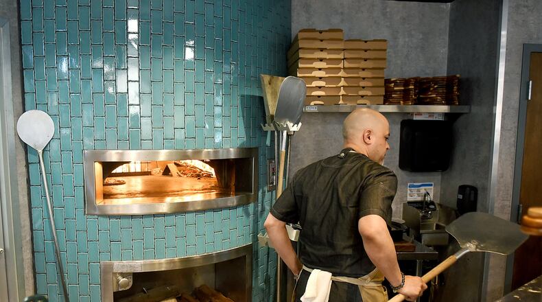 The wood-fired pizza oven is part of the appeal of Forno Vero Neapolitan Kitchen at Marietta Square Market. RYON HORNE / RHORNE@AJC.COM