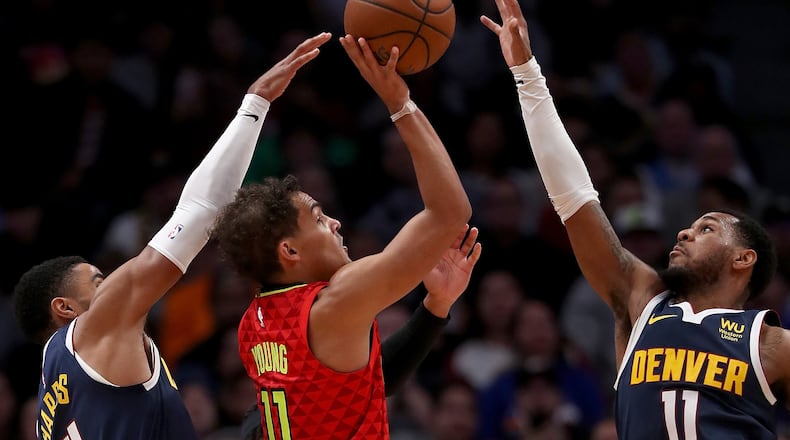 Trae Young of the Hawks puts up a shot against the Nuggets. (Photo by Matthew Stockman/Getty Images)
