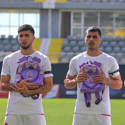 Iran's players sing national anthem holding school bags symbolizing children allegedly killed in a U.S. strike on a school in Minab before a friendly soccer match between Iran and Nigeria, in Antalya, southern Turkey, Friday, March 27, 2026. (AP Photo/Riza Ozel)
