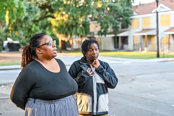 Residents Shana Williams (left) and Kevina Atkinson (right) stand surrounded by boarded-up units of Yamacraw Village. (Sarah Peacock for the AJC)