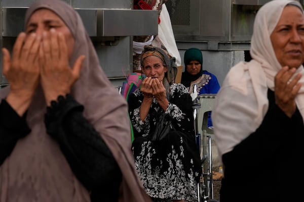 FILE - Muslim pilgrims pray after casting stones at pillars in the symbolic stoning of the devil during the annual hajj, as it rains in Mina, near the holy city of Mecca, Saudi Arabia, Monday, June 17, 2024. (AP Photo/Rafiq Maqbool, File)