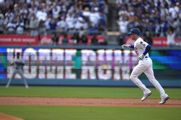 Los Angeles Dodgers' Freddie Freeman rounds second after hitting a solo home run during the first inning of a baseball game against the Detroit Tigers Saturday, March 29, 2025, in Los Angeles. (AP Photo/Mark J. Terrill)