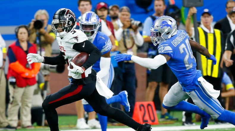 Atlanta Falcons wide receiver Drake London runs ahead of Detroit Lions cornerback Amani Oruwariye (24) during the first half of a preseason NFL football game, Friday, Aug. 12, 2022, in Detroit. (AP Photo/Duane Burleson)