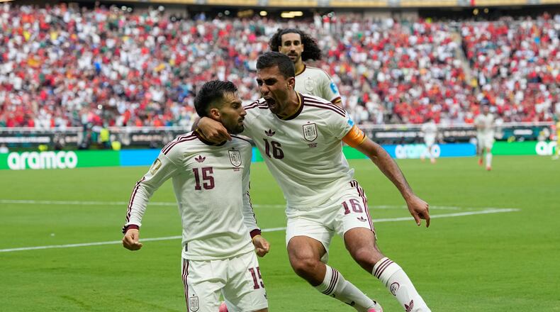 Spain's Alex Baena, left, is congratulated after scoring his side's opening goal by Rodri during the World Cup Group H soccer match between Uruguay and Spain in Zapopan, near Guadalajara, Mexico, Friday, June 26, 2026. (AP Photo/Natacha Pisarenko)