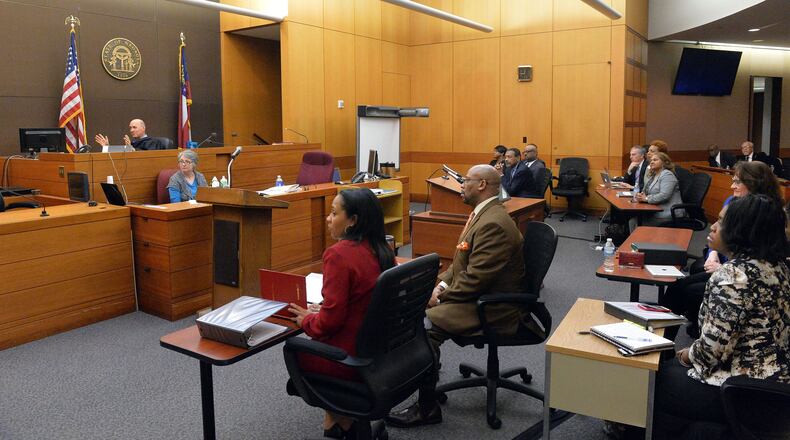 Fulton County Chief Senior Assistant District Attorney Fani Willis and Senior ADA Clint Rucker listen Thursday as Fulton County Superior Court Judge Jerry Baxter answers a question from the jury about evidence in the Atlanta Public Schools test-cheating trial in Fulton County Superior Court. (Kent D. Johnson, The Atlanta Journal-Constitution)