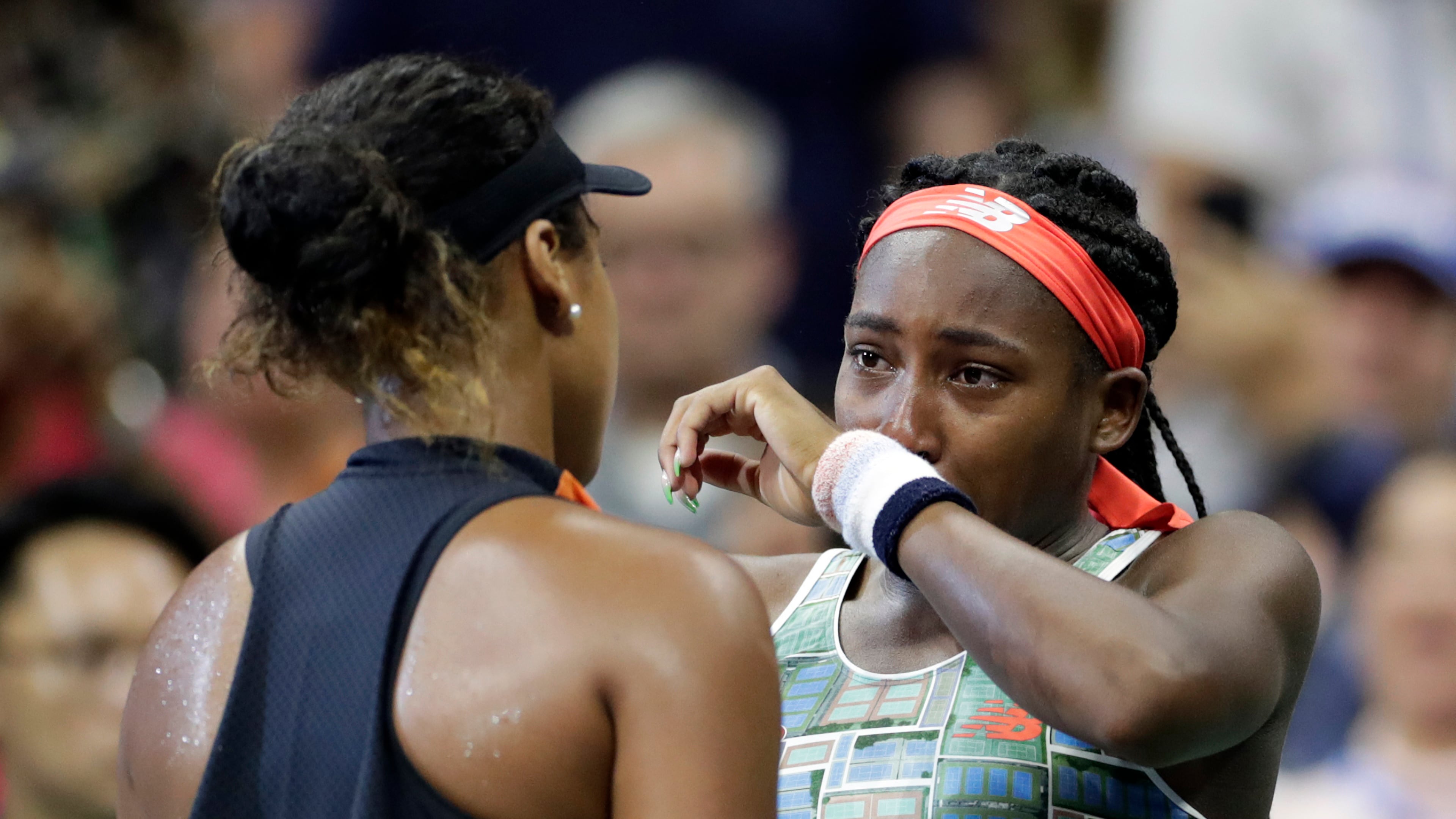 FILE - Coco Gauff, right, of the United States, wipes away tears while talking to Naomi Osaka, of Japan, after Osaka defeated Gauff in the third round of the U.S. Open tennis tournament Saturday, Aug. 31, 2019, in New York. (AP Photo/Adam Hunger, File)