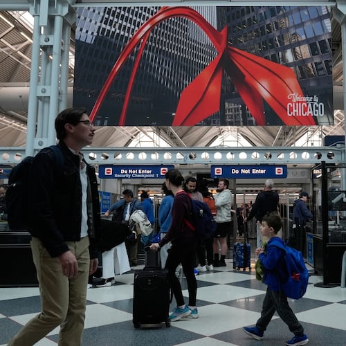 Travelers go through TSA security check at O'Hare International Airport, Saturday, March 21, 2026, in Chicago. (AP Photo/Kiichiro Sat0)