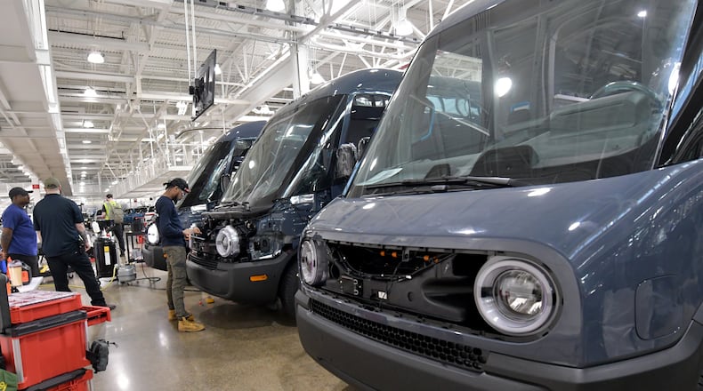 Manufacturing workers assemble electric vehicles including the Rivian Amazon EDV 700 at Rivian in Normal, Ill., on July 20, 2022. (Photo for the Atlanta Journal Constitution by Ron Johnson)