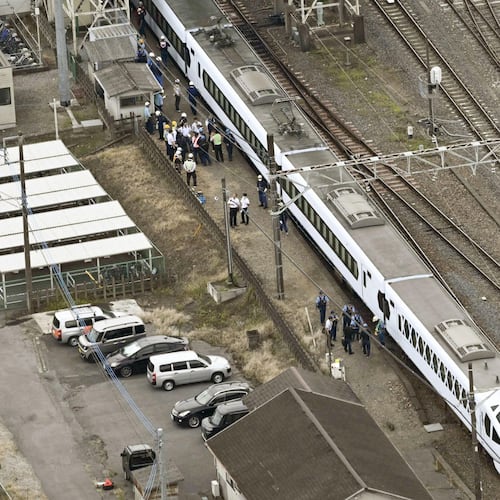 This aerial photo shows, the Spacia X express train stopped after coming into contact with four workers at Shin-Kanuma Station on the Tobu Nikko Line in Kanuma, north of Tokyo, Thursday, Aug. 20, 2026. (Kyodo News via AP)