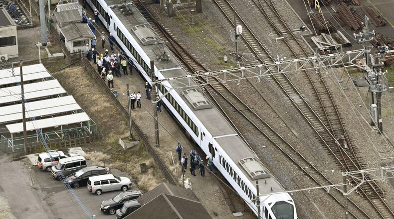 This aerial photo shows, the Spacia X express train stopped after coming into contact with four workers at Shin-Kanuma Station on the Tobu Nikko Line in Kanuma, north of Tokyo, Thursday, Aug. 20, 2026. (Kyodo News via AP)