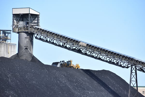 A heavy machinery operator is seen moving coal at Signal Peak Energy's Bull Mountains Mine, on May 21, 2025, near Roundup, Montana. (AP Photo/Matthew Brown)