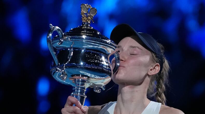 Elena Rybakina of Kazakhstan kisses the Daphne Akhurst Memorial Cup after defeating Aryna Sabalenka of Belarus to win the women's singles final at the Australian Open tennis championship in Melbourne, Australia, Saturday, Jan. 31, 2026. (AP Photo/Aaron Favila)