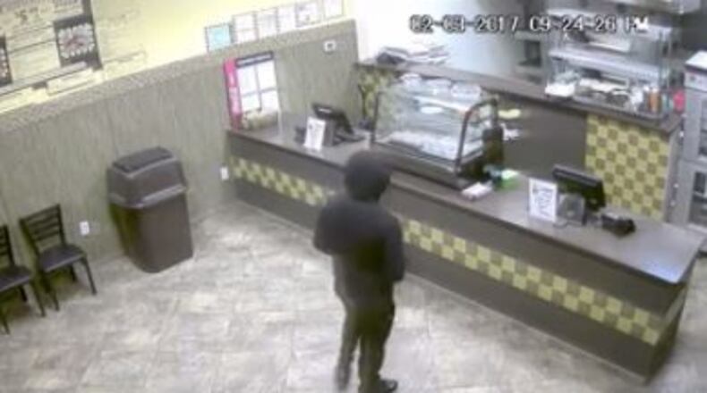 DeKalb County police are searching for a suspect accused of holding up a pizza place on Feb. 3.