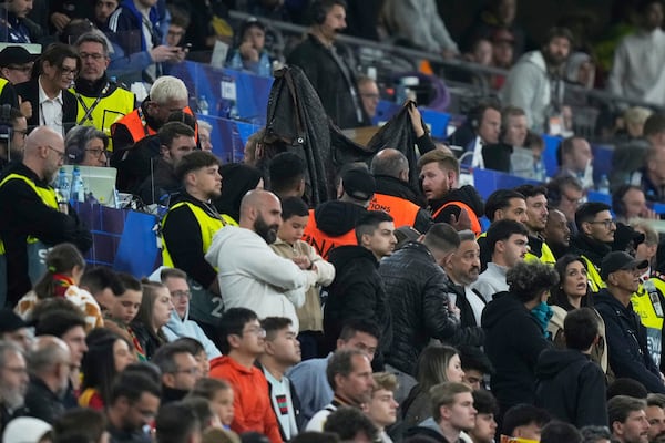 Stewards hold a blanket as a spectator is treated after falling during the Nations League final soccer match between Portugal and Spain at the Allianz Arena in Munich, Germany, Sunday, June 8, 2025. (AP Photo/Matthias Schrader)