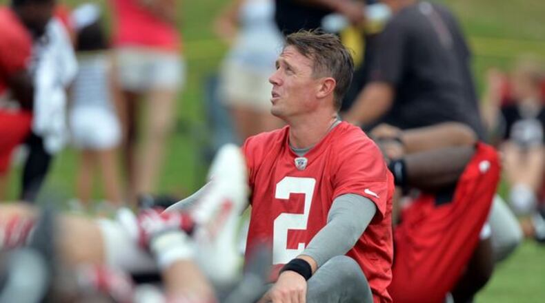 Falcons QB Matt Ryan knows how to tackle. Here he is as he stretches during the minicamp. Atlanta Falcons players workout during the second day of mini-camp at the team's facilities in Flowery Branch, Wednesday, June 18, 2014. KENT D. JOHNSON/KDJOHNSON@AJC.COM