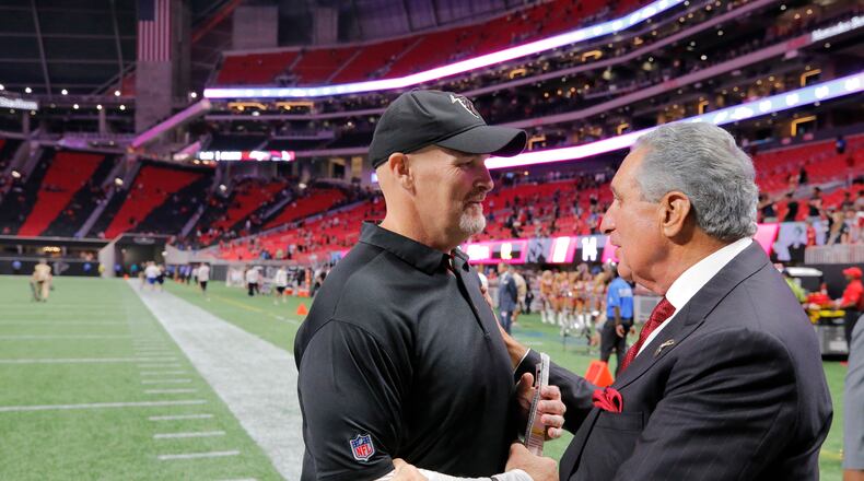 Falcons owner Arthur Blank greets coach Dan Quinn after an Aug. 26 exhibition game.